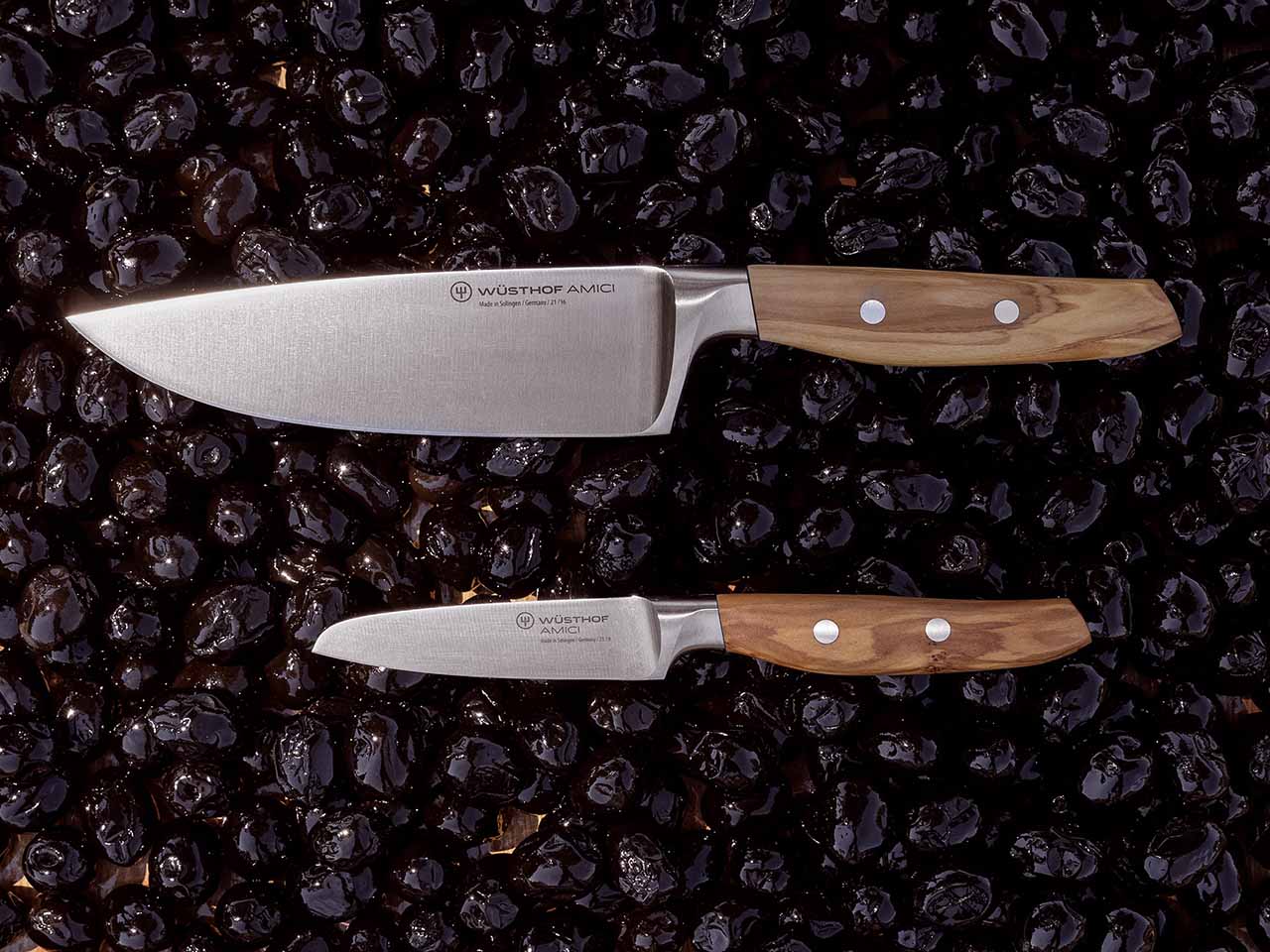 Amici 8" chef's knife and 2.5" paring knife on a bed of black olives