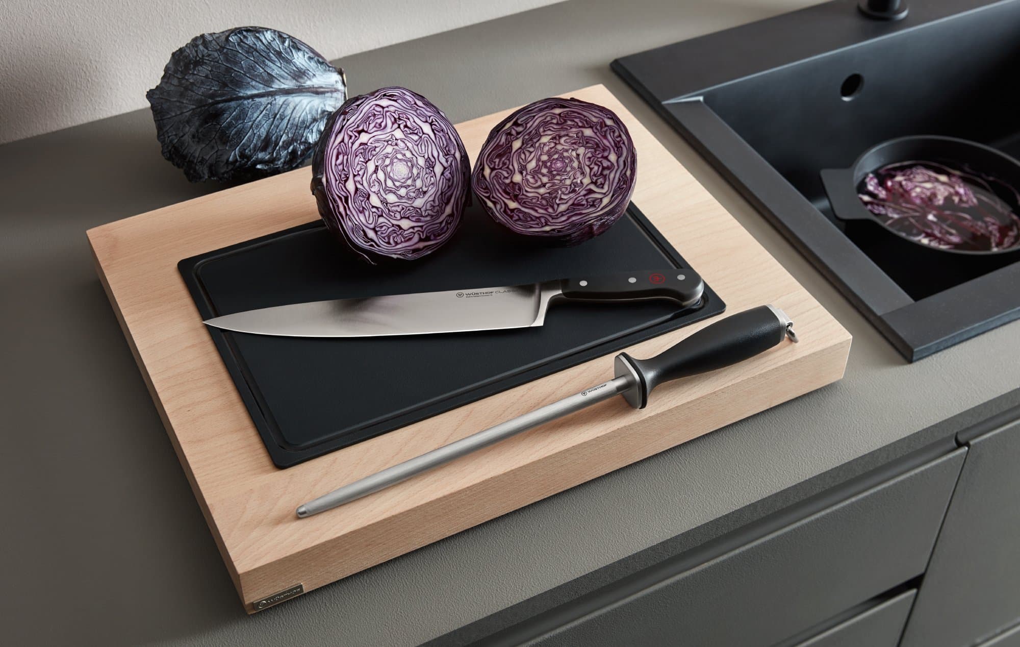 Wusthof Knife and sharpening honing steel next to a freshly-cut red cabbage