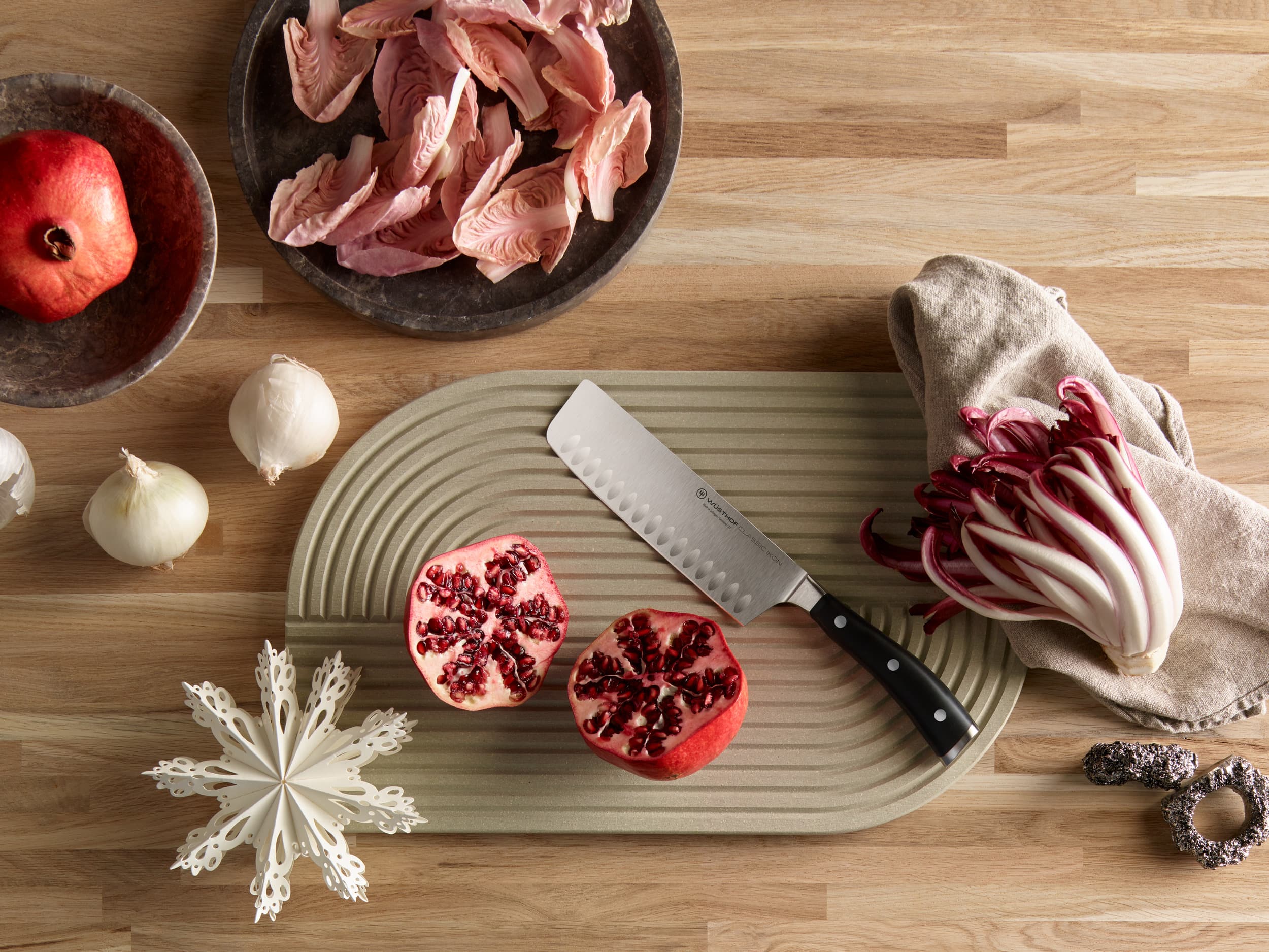 knife on table next to pomegranate