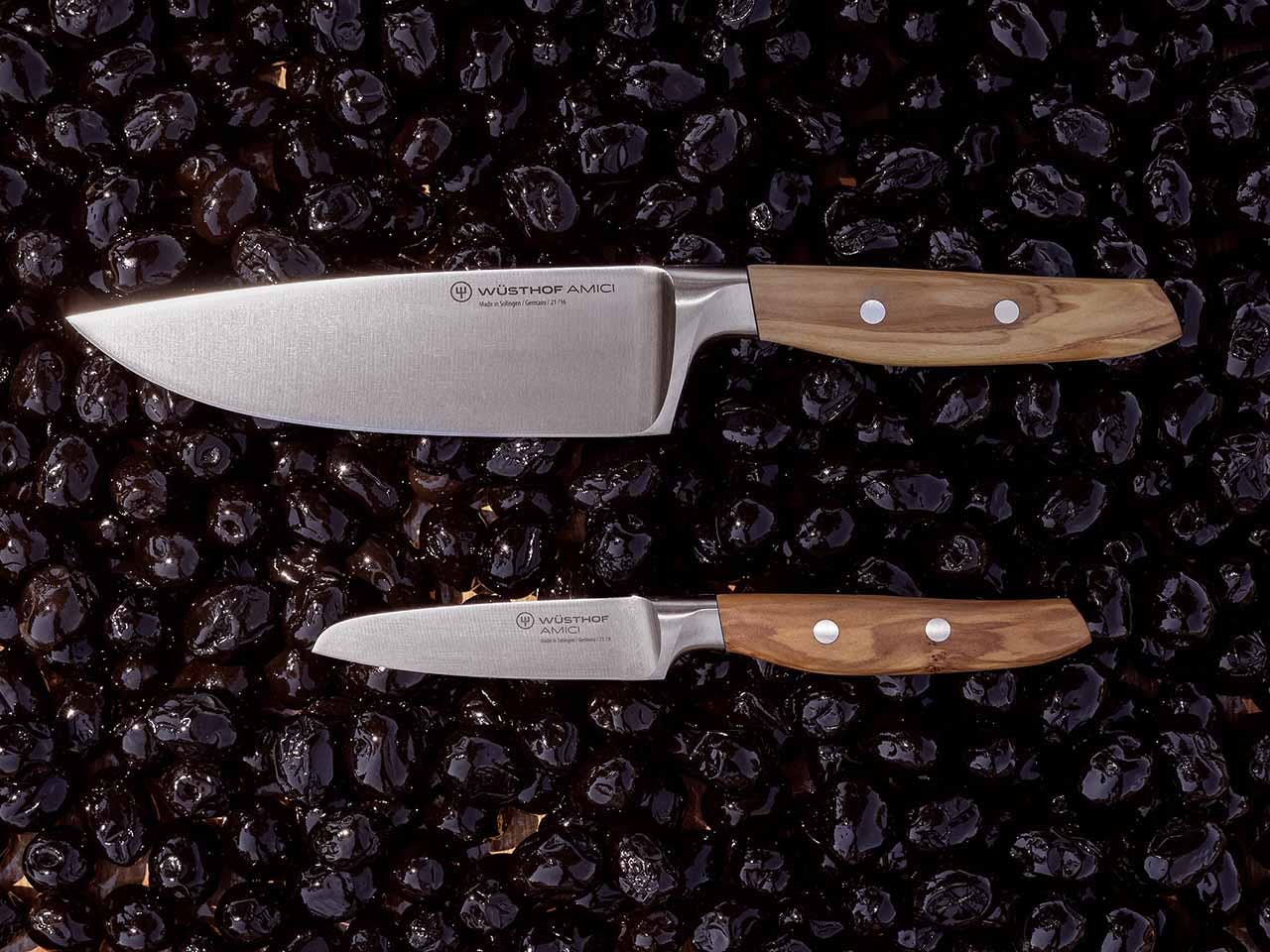 Amici 8" chef's knife and 2.5" paring knife on a bed of black olives
