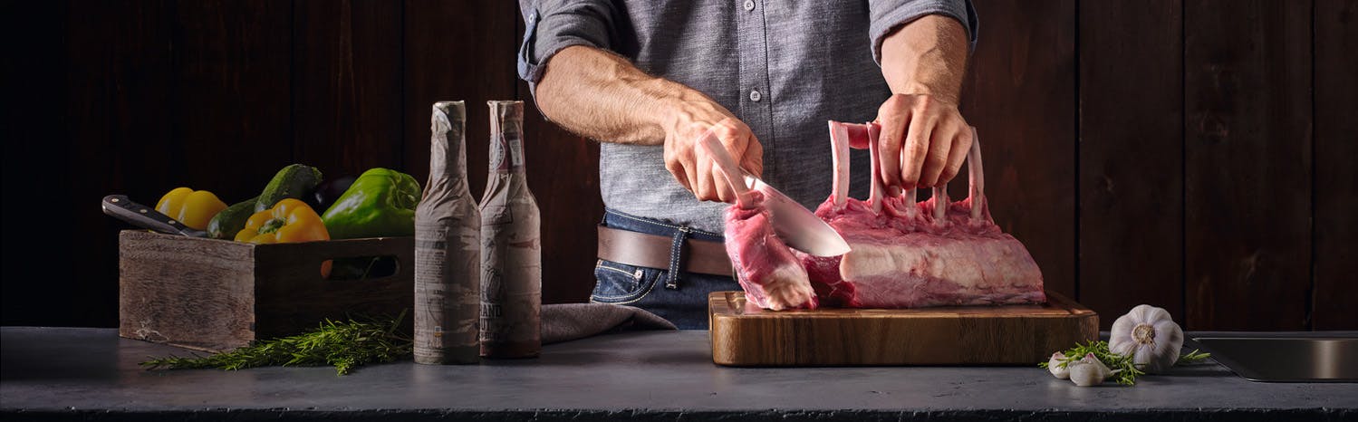 Image of chef slicing a beef rack with the crafter chef's knife