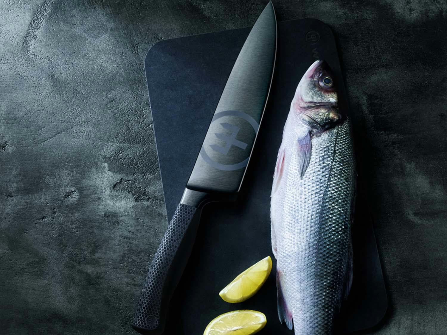 Image of a performer chef's knife and a fish on a cutting board