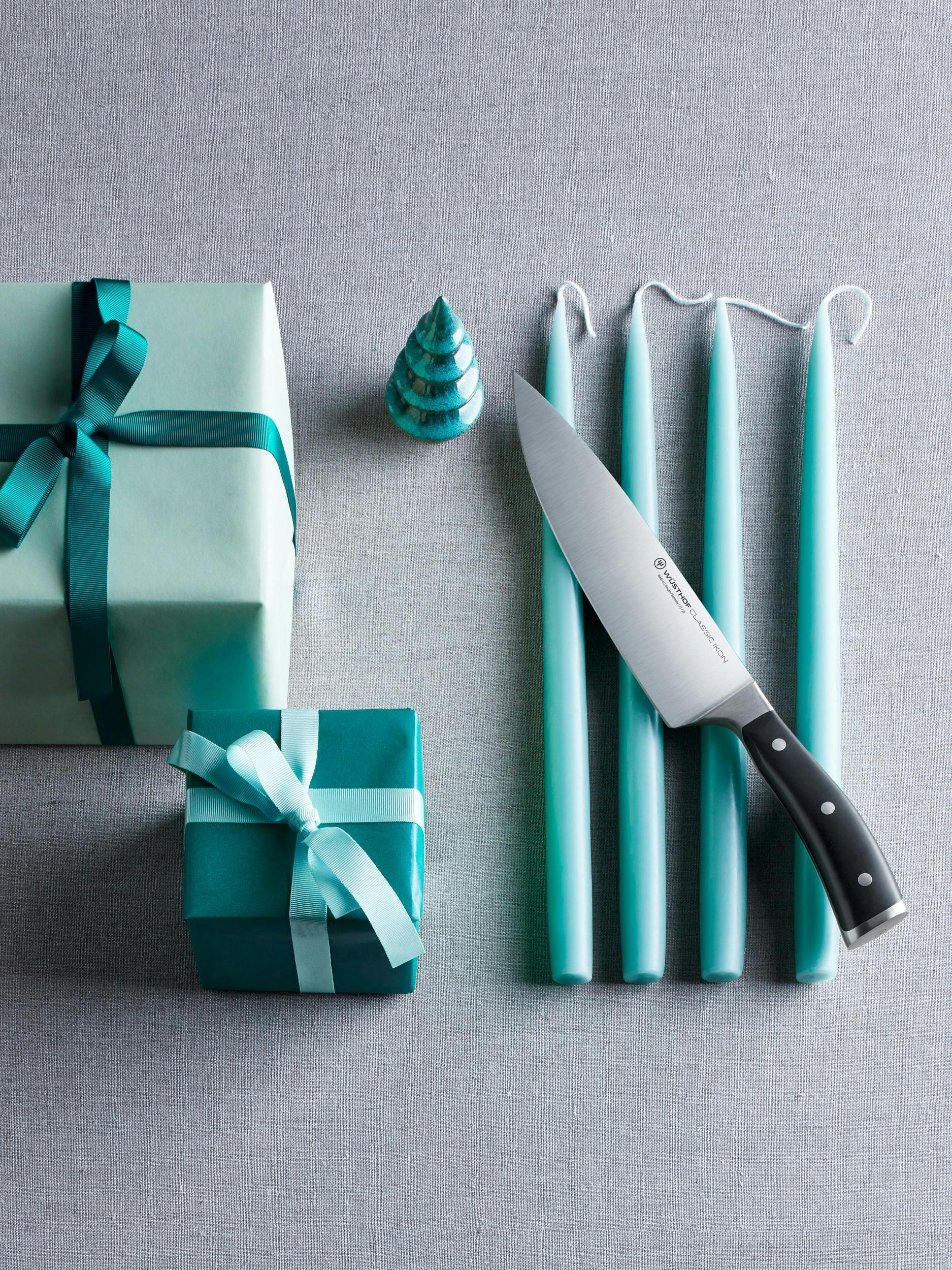 Classic Ikon knife styled next to blue candles and presents