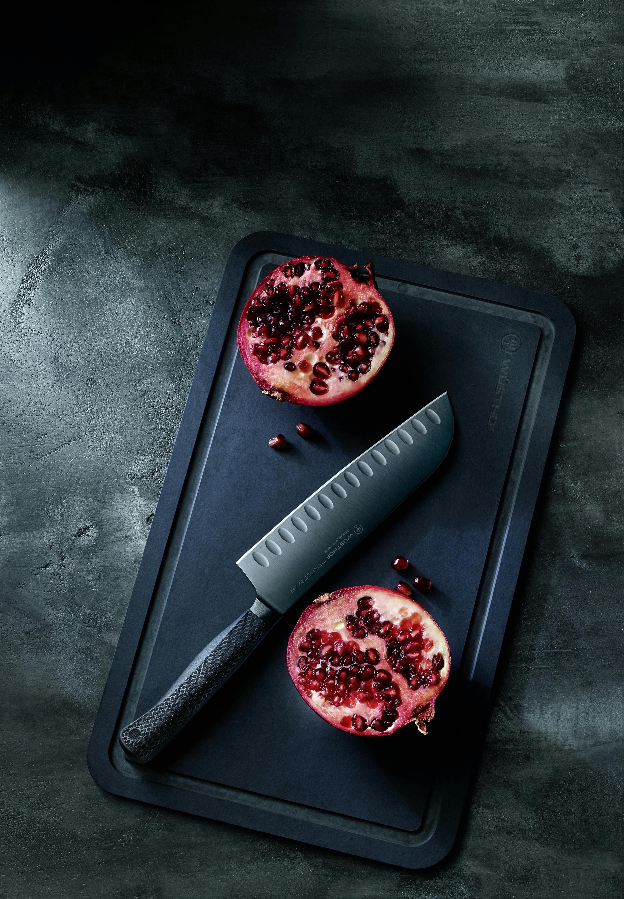 Performer santoku on cutting board with seeded fruit